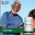 Older Black man smiling outdoors while holding a bottle of OliPureBP, showcasing a healthy lifestyle and supplement choice.