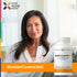 A middle-aged woman smiles next to a BladderControl360 bottle.