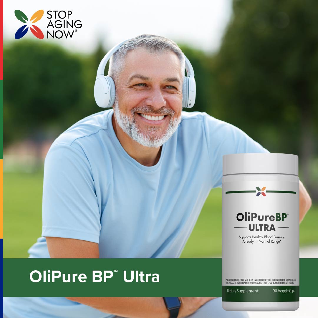 Lifestyle image of smiling man wearing headphones outdoors with OliPure BP Ultra bottle nearby.