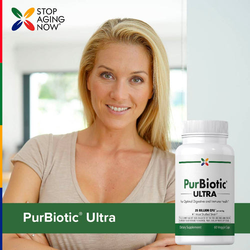 View 8 A middle-aged woman smiling and holding a bottle of PurBiotic Ultra.