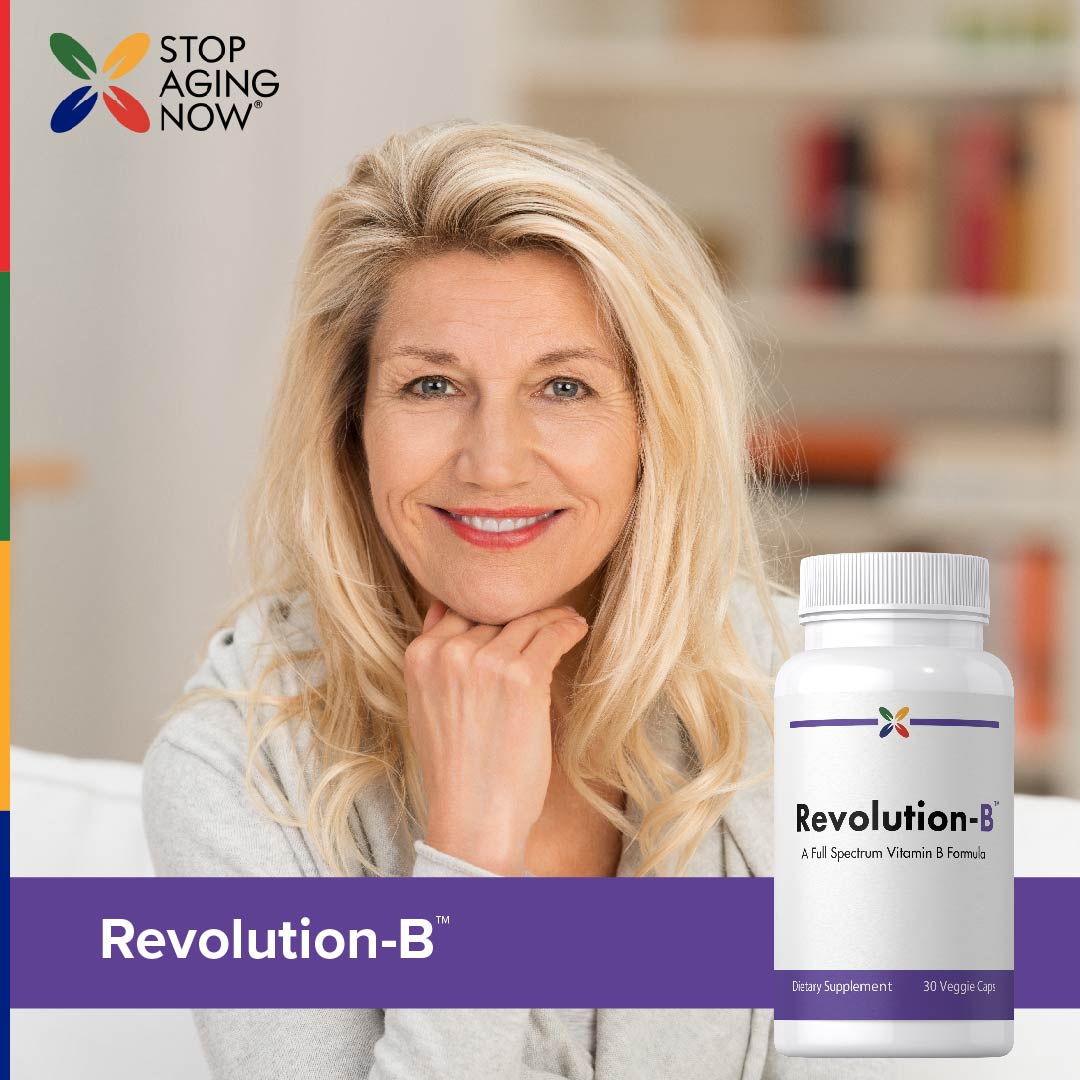 Middle-aged woman smiling and resting her chin on her hand next to a Revolution-B bottle.