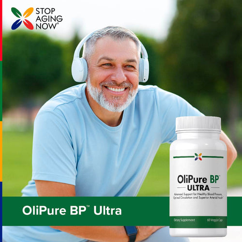 View 6 Middle-aged man smiling outdoors with headphones, holding a bottle of OliPure BP ULTRA.