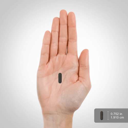 View 2 Hand holding a small black rectangular object with measurement label on a gray background