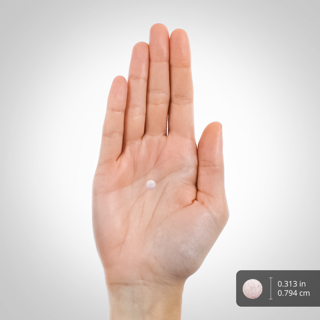 A small round lozenge, 0.313 inches (0.794 cm) in diameter, held in the palm of a hand.